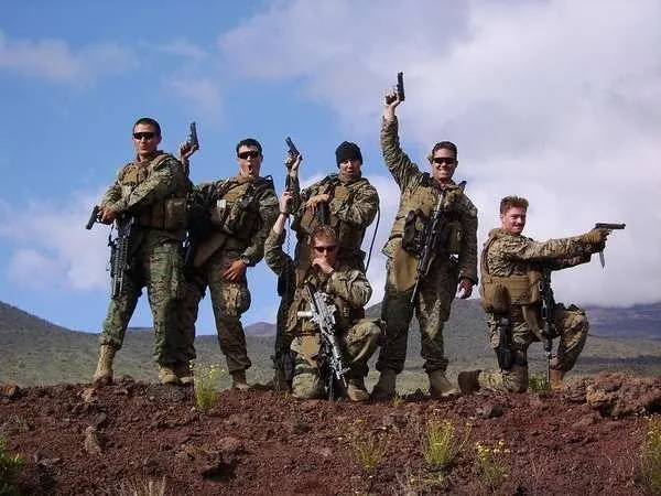 A Recon team posing on a rocky hill in Iraq