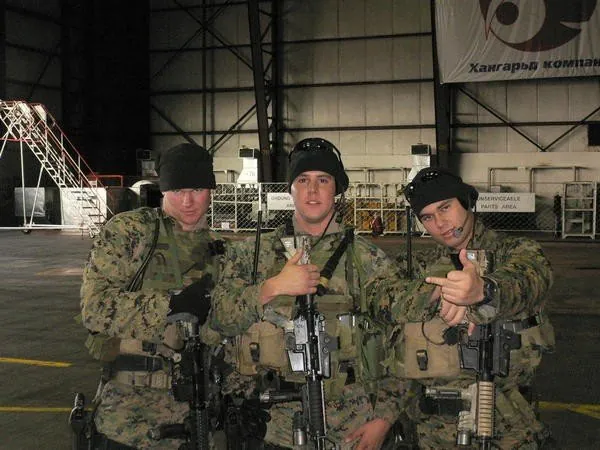 Three Recon Marines and a corpsman in a hangar in Mongolia