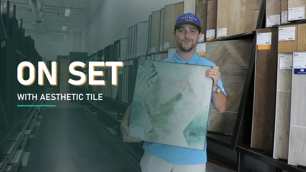 Brad Fleitz grins and holds up a hexagon tile under the title On Set with Aesthetic Tile